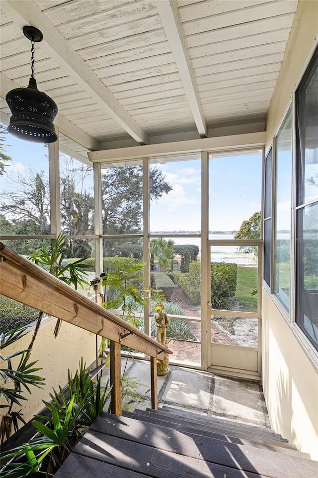 sunroom featuring wooden ceiling, beamed ceiling, and a water view