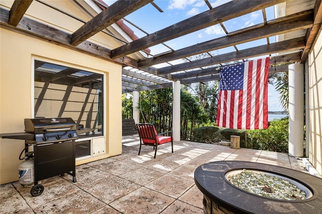 view of patio / terrace with a grill, a pergola, and an outdoor fire pit