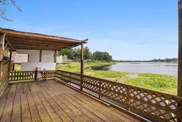 wooden deck featuring a water view