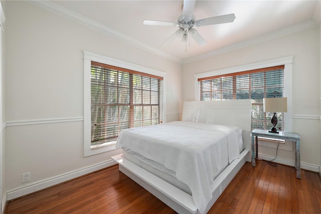 bedroom with crown molding, ceiling fan, and dark hardwood / wood-style floors
