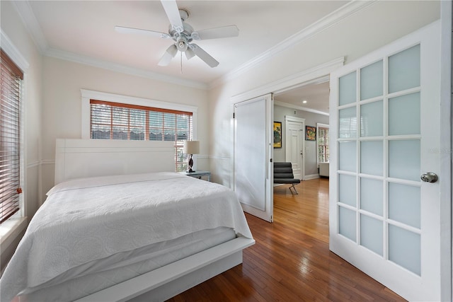bedroom featuring wood-type flooring, ceiling fan, and crown molding