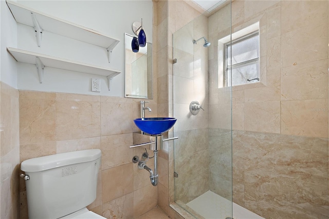 bathroom featuring sink, tile walls, an enclosed shower, and toilet