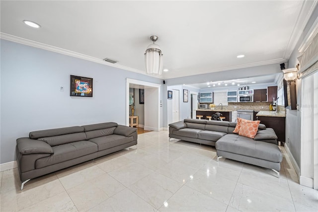 living room with crown molding and sink