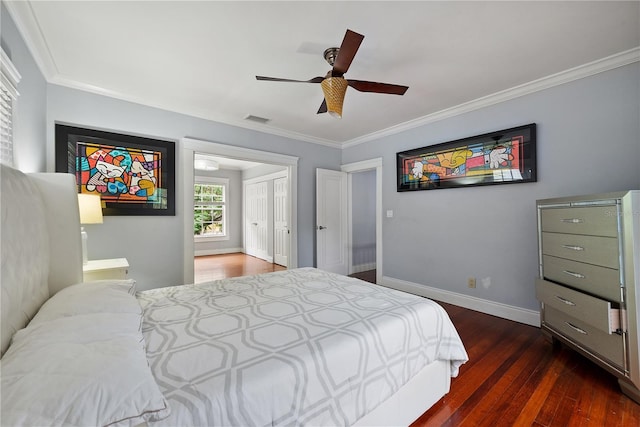 bedroom featuring dark wood-type flooring, ceiling fan, and ornamental molding