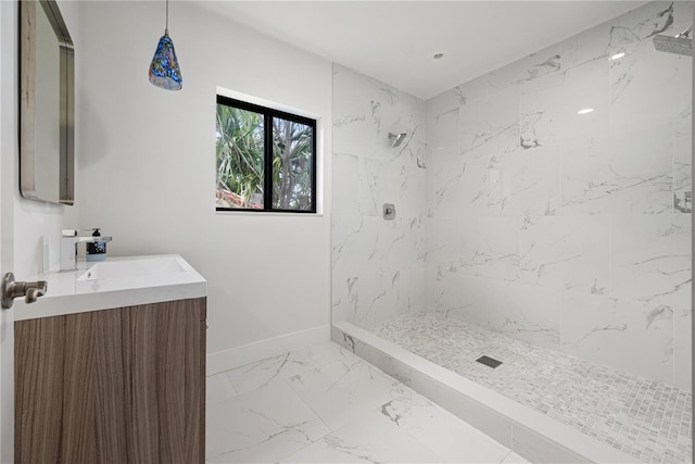 bathroom with vanity and a tile shower