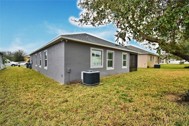 view of property exterior featuring a yard and central AC