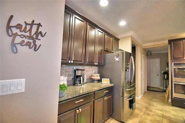 kitchen featuring tasteful backsplash, light stone countertops, dark brown cabinets, and stainless steel appliances