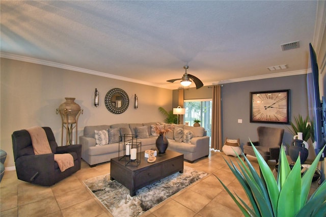 tiled living room with ceiling fan, ornamental molding, and a textured ceiling