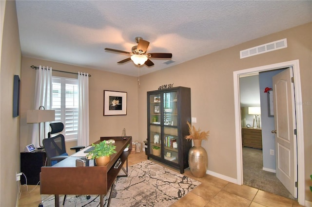 office featuring ceiling fan, a textured ceiling, and light tile patterned floors