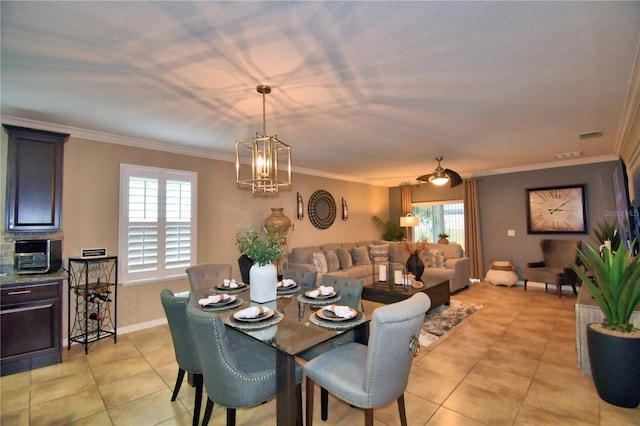 dining space featuring ornamental molding, a chandelier, and light tile patterned flooring