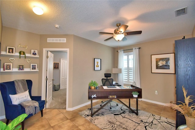 home office featuring light tile patterned floors, a textured ceiling, and ceiling fan