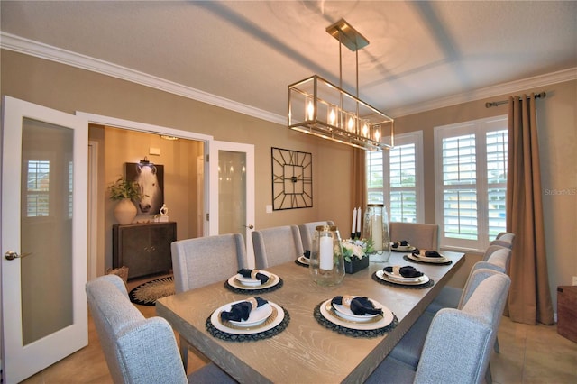 tiled dining space with french doors, ornamental molding, and a chandelier