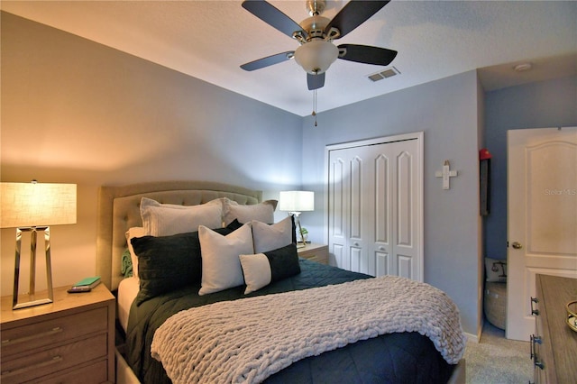 carpeted bedroom with a closet and ceiling fan