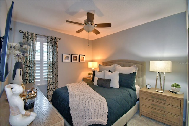 bedroom featuring light carpet and ceiling fan