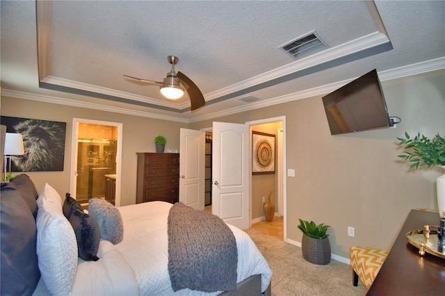 carpeted bedroom featuring ceiling fan, crown molding, a raised ceiling, and a textured ceiling