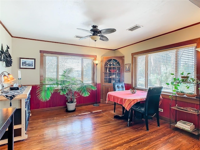 dining space featuring ceiling fan, ornamental molding, and dark hardwood / wood-style flooring