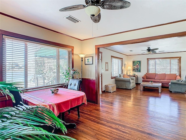 dining area with crown molding, dark hardwood / wood-style floors, and ceiling fan