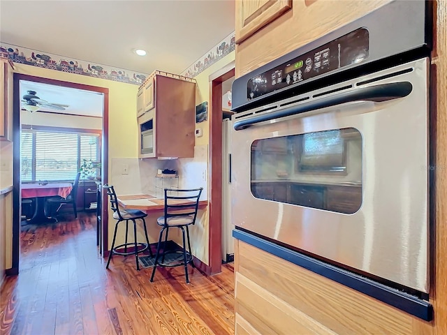 kitchen with wood-type flooring and appliances with stainless steel finishes