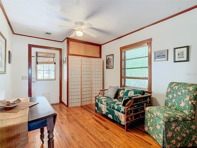 sitting room featuring ornamental molding, a wealth of natural light, light hardwood / wood-style floors, and ceiling fan