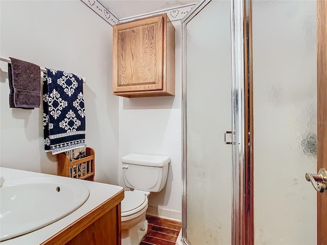 bathroom with vanity, hardwood / wood-style floors, an enclosed shower, and toilet