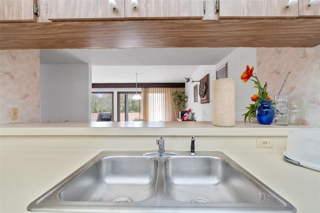 interior details featuring sink and decorative light fixtures