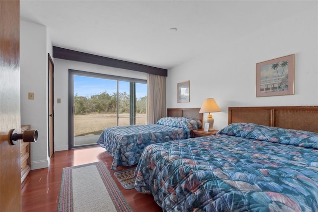 bedroom featuring dark wood-type flooring and access to outside