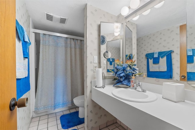 bathroom with tile patterned flooring, sink, curtained shower, and toilet