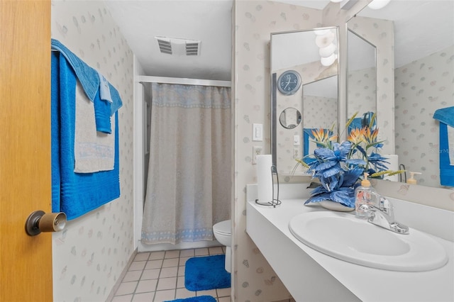 bathroom with vanity, tile patterned floors, and toilet