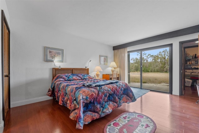 bedroom with access to exterior and hardwood / wood-style flooring