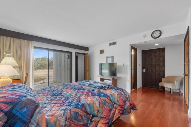 bedroom featuring hardwood / wood-style flooring and access to outside