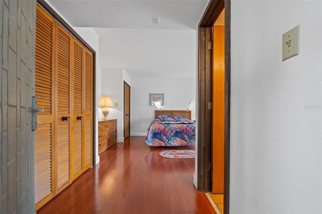 corridor with hardwood / wood-style floors