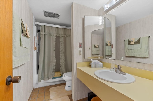 full bathroom featuring shower / tub combo with curtain, vanity, tile patterned floors, and toilet