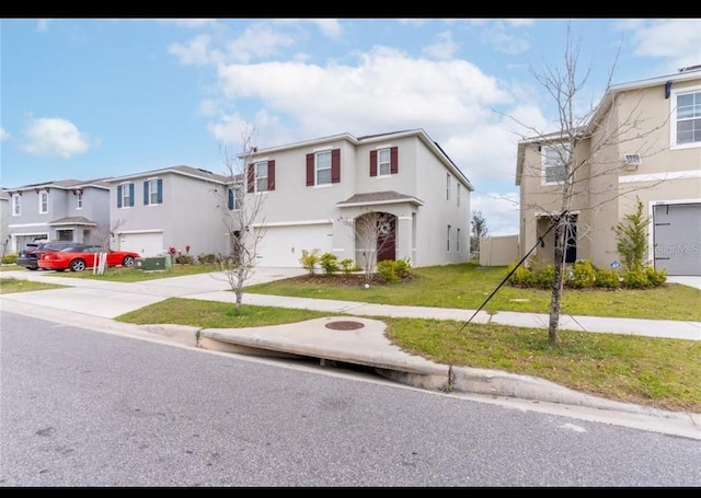 view of front of property featuring a garage and a front lawn