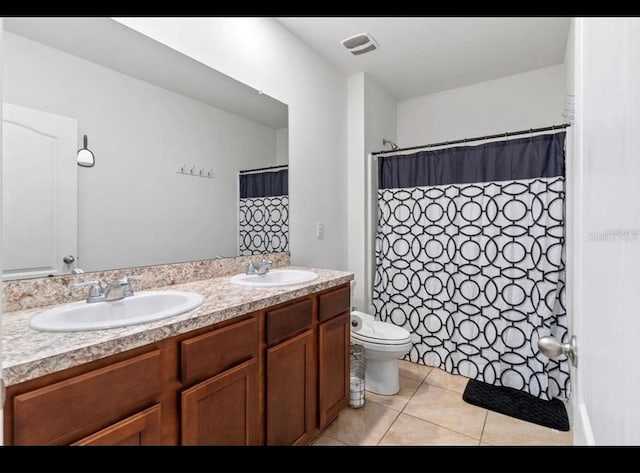 bathroom with vanity, tile patterned floors, and toilet