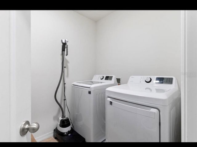 clothes washing area featuring washer and dryer