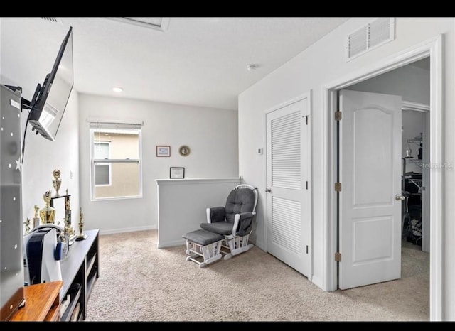 living area featuring light carpet