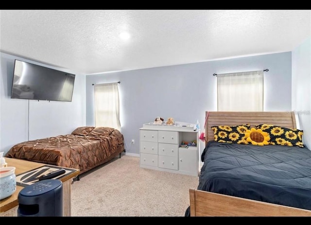 carpeted bedroom featuring a textured ceiling