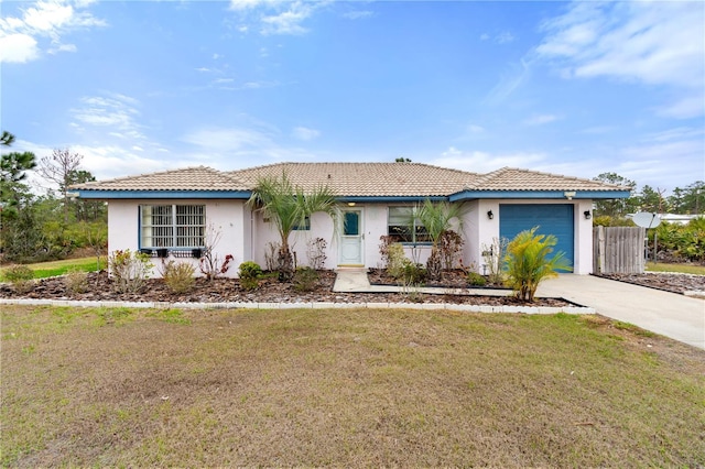 view of front facade featuring a garage and a front lawn