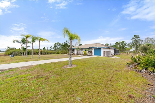 ranch-style home featuring a garage and a front lawn