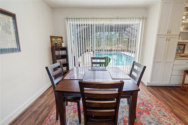 dining space with dark hardwood / wood-style floors