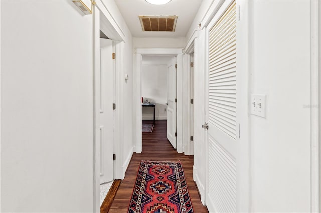 corridor featuring dark hardwood / wood-style flooring