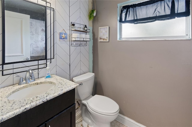 bathroom with vanity, tasteful backsplash, tile walls, and toilet