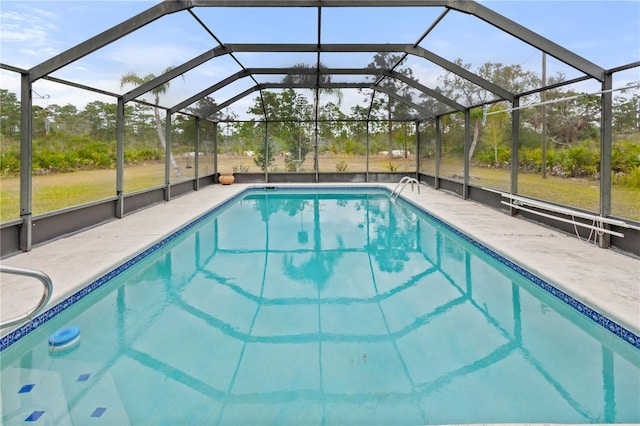 view of pool with a patio and glass enclosure