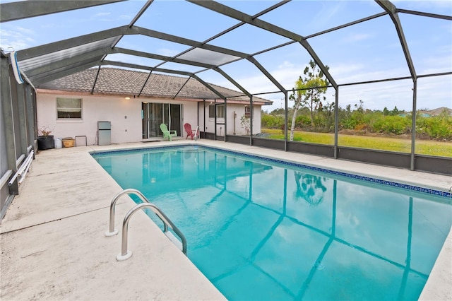 view of swimming pool with a lanai and a patio area