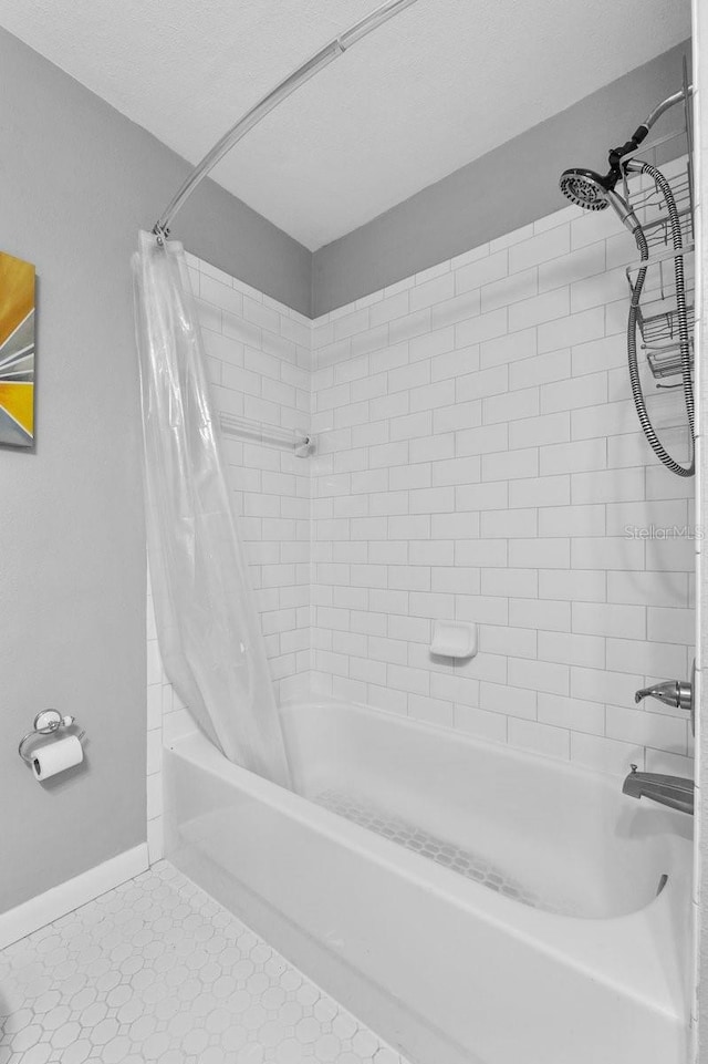 bathroom with shower / bathtub combination with curtain