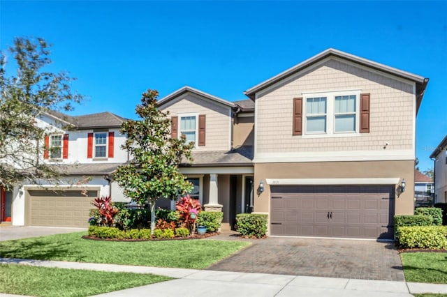 view of front of property with a garage and a front yard