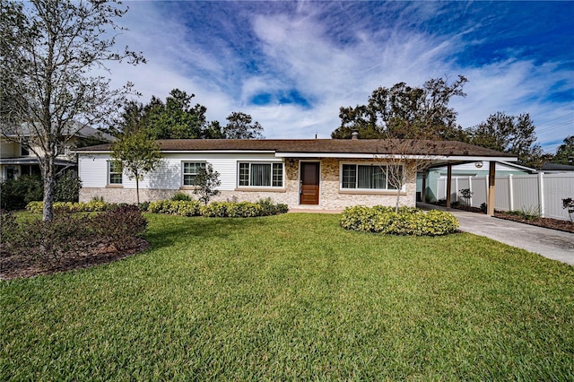 ranch-style house featuring a front yard and a carport