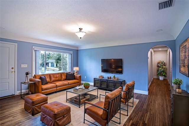 living room featuring hardwood / wood-style floors and a textured ceiling