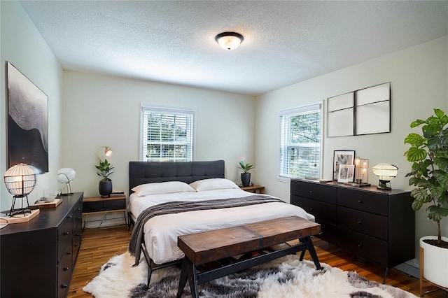 bedroom featuring hardwood / wood-style flooring and a textured ceiling