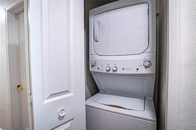 washroom with stacked washing maching and dryer